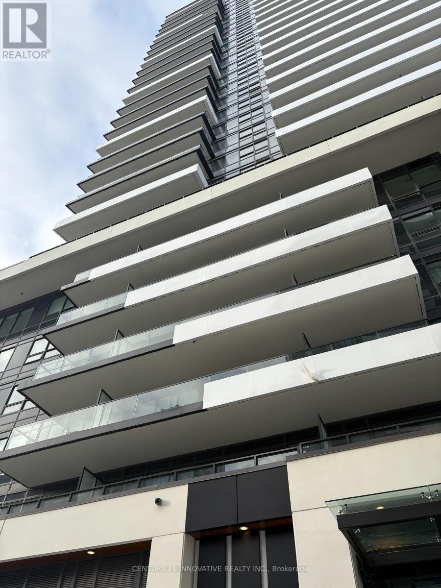 A tall building with balconies and a sign that says "REALTOR".