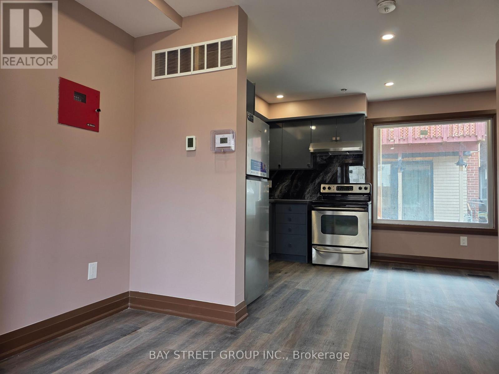 A kitchen area with a stove and a refrigerator.