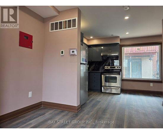 A kitchen area with a stove and a refrigerator.