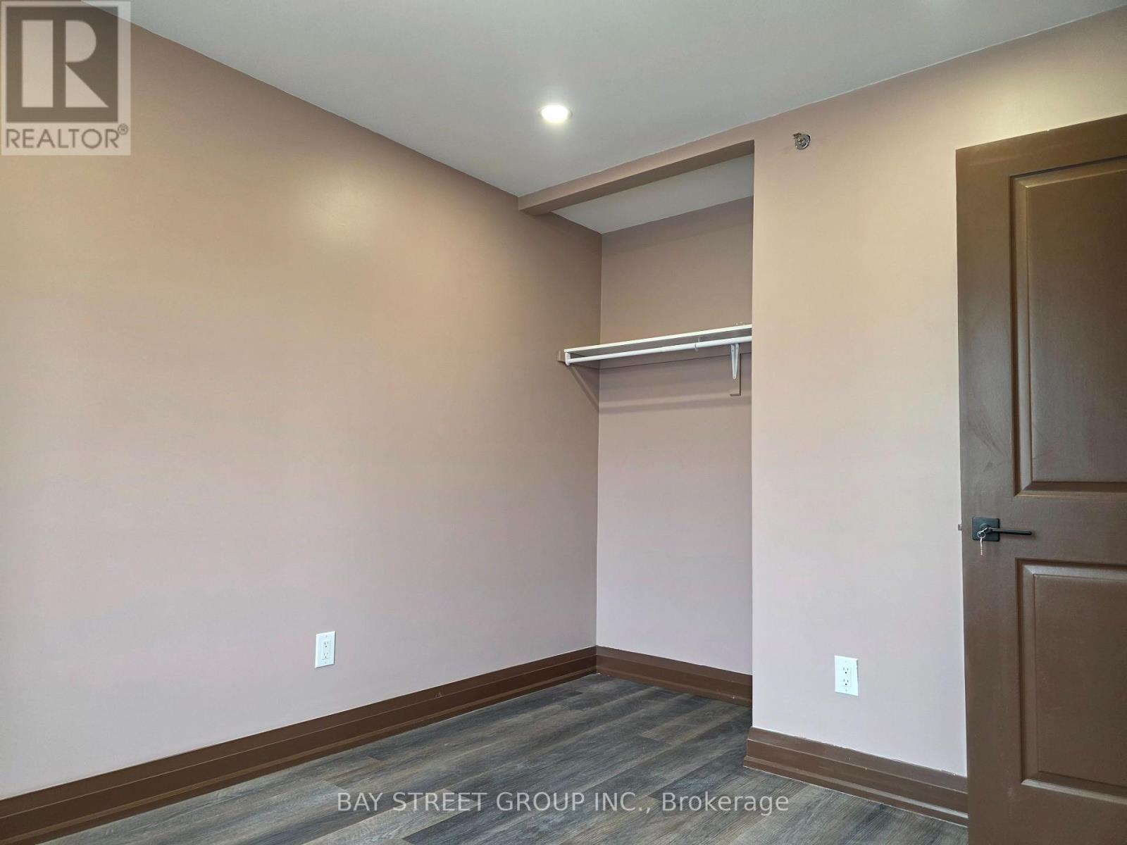 A room with a door and a shelf in it.