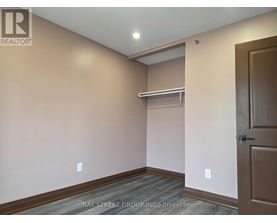 A room with a door and a shelf in it.