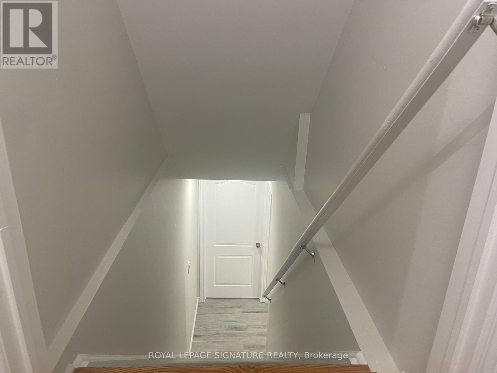 A hallway with a door at the end.