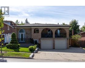 A house with a garage and a driveway is for sale.