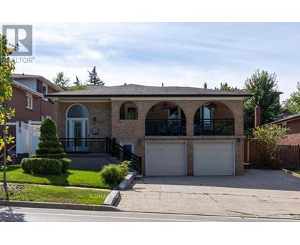 A house with a garage and a driveway is for sale.