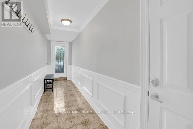 A hallway with a bench and a door.
