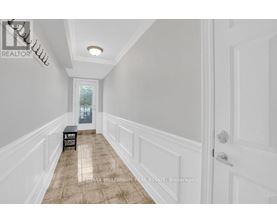 A hallway with a bench and a door.