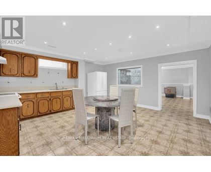A dining room with a table and chairs is shown.