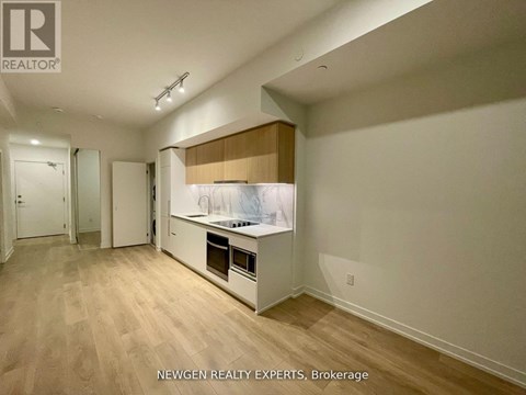 A kitchen area with a countertop and cabinets.