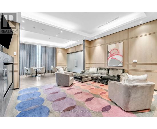 A living room with a large rug and a couch.