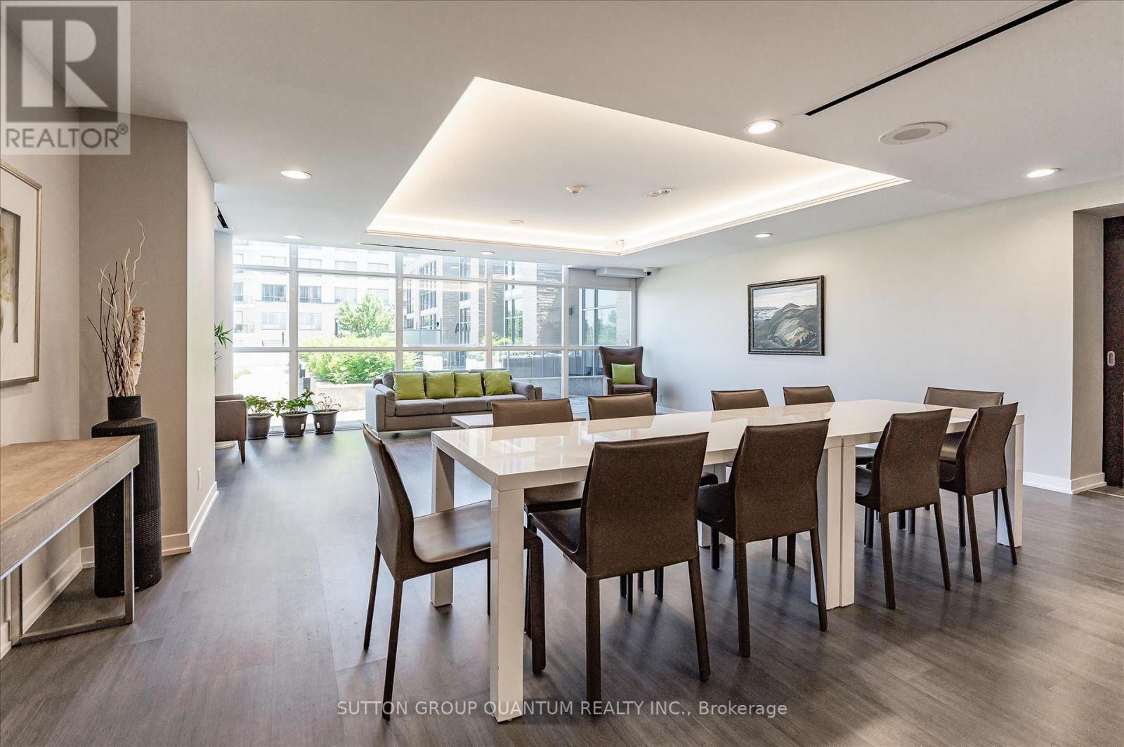 A dining room with a long table and chairs.