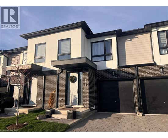 A modern house with a black garage door is for sale.