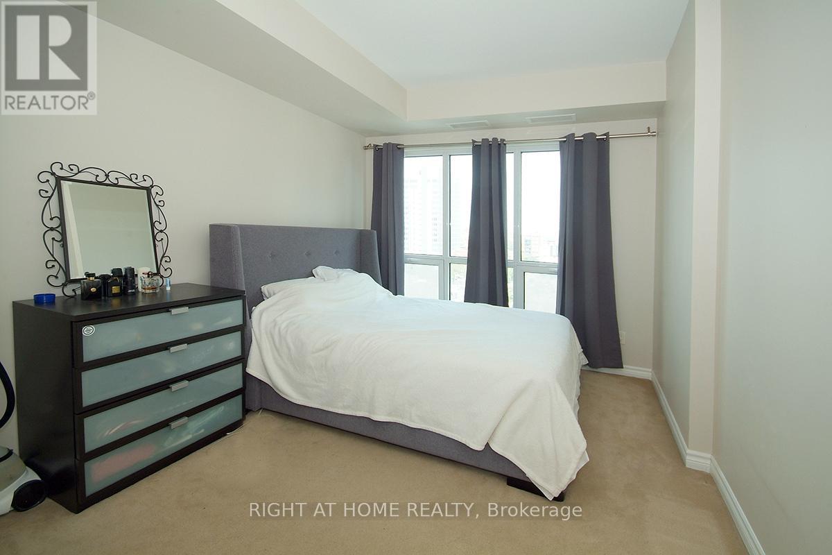 A bedroom with a bed, dresser, and mirror.