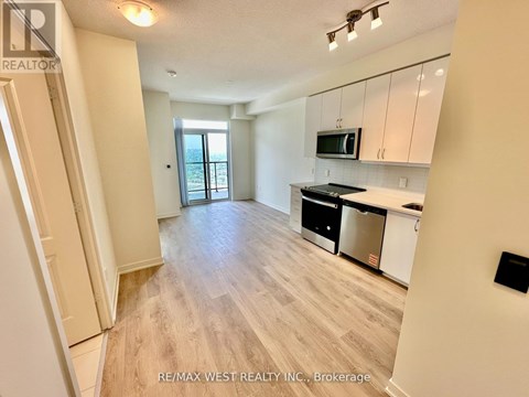 A spacious kitchen with white cabinets and a dining area with a table and chairs.