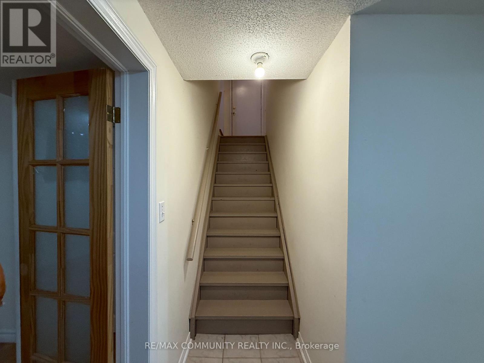 A hallway with a staircase leading to the second floor.