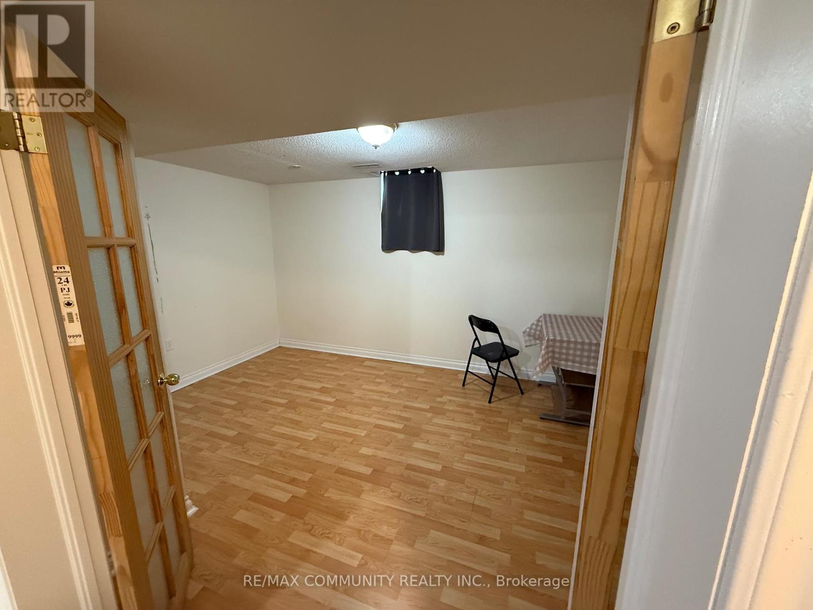 A room with wooden flooring and a chair.