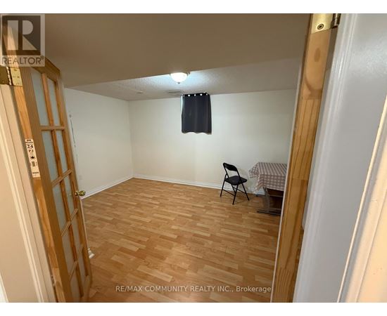 A room with wooden flooring and a chair.