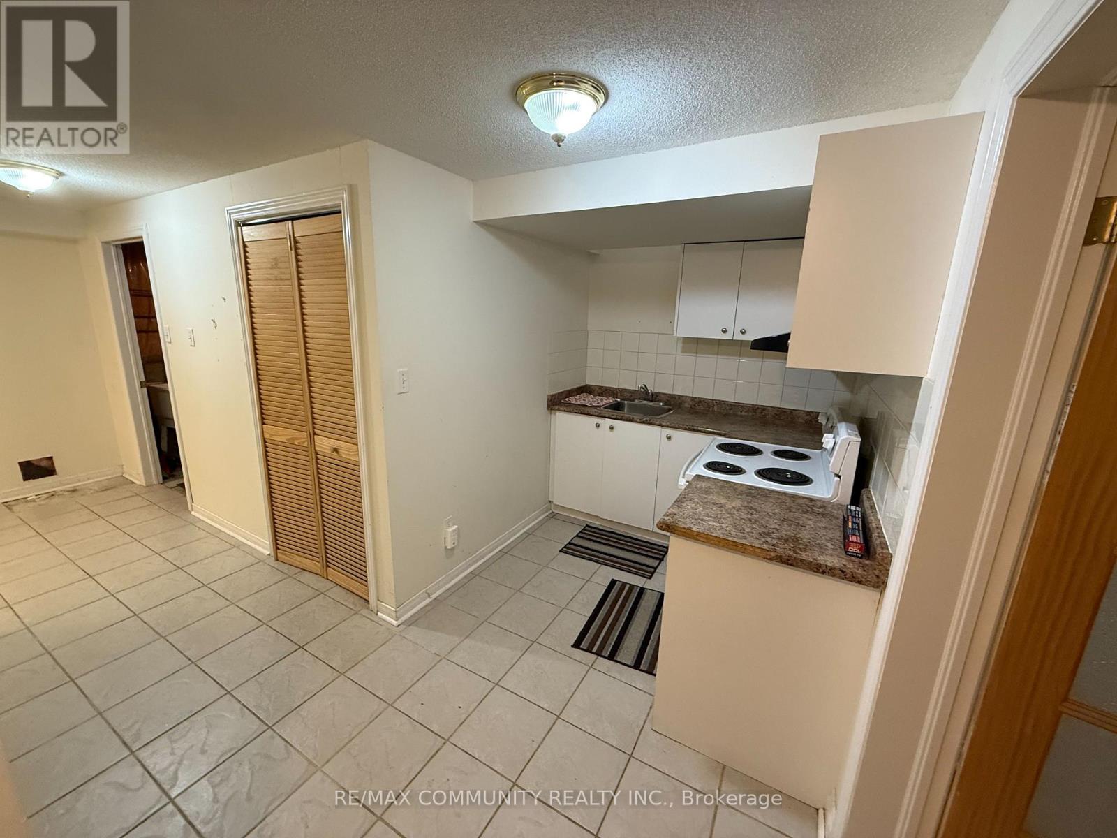 A kitchen area with a stove top oven and a counter.