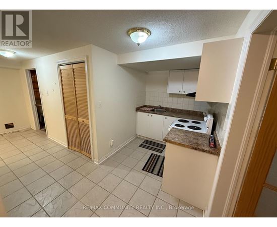 A kitchen area with a stove top oven and a counter.