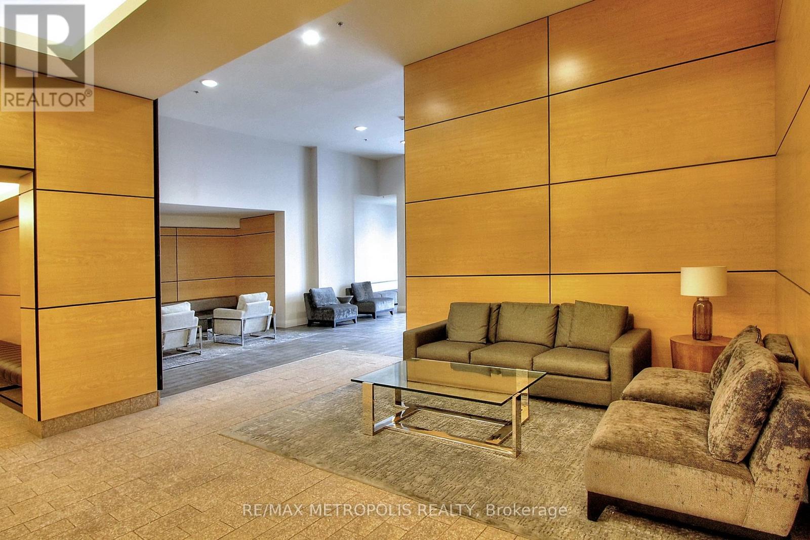A living room with a couch, chair, and coffee table.