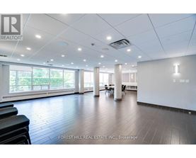 A spacious office room with a view of trees outside the windows.