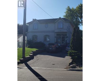 A house with a car parked in front of it.