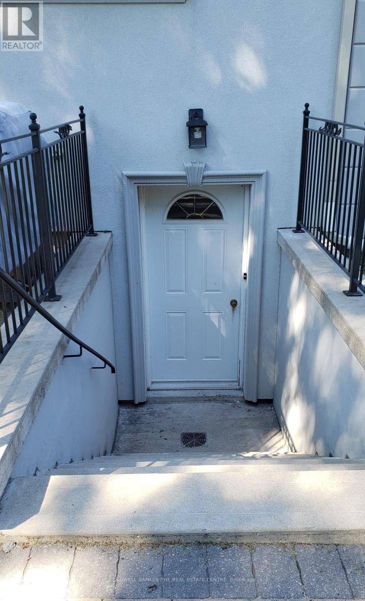 A white door with a black railing on either side.