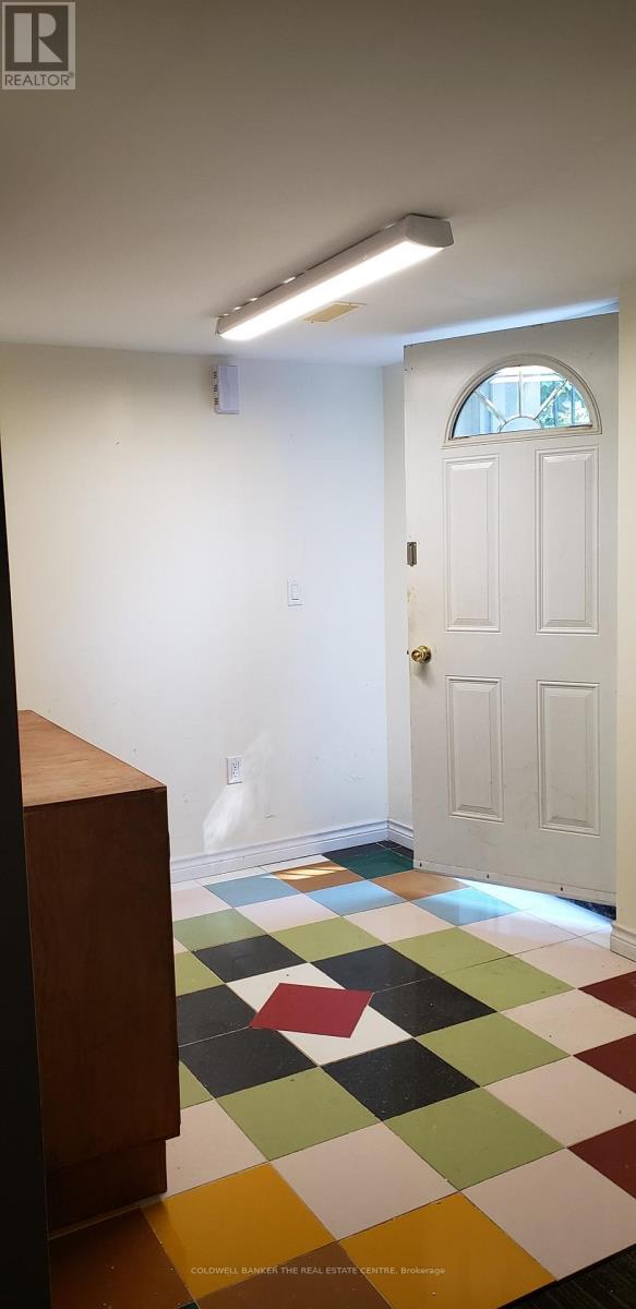 A white door is in a room with a checkered floor.
