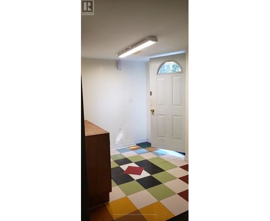 A white door is in a room with a checkered floor.