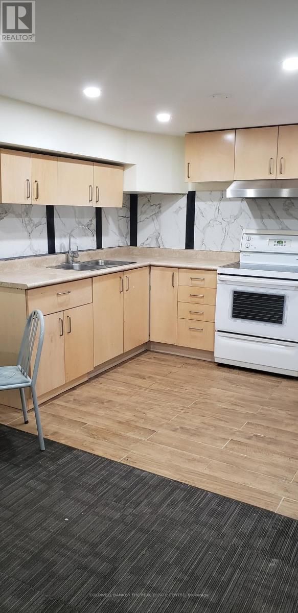 A kitchen with wooden cabinets and a white oven.