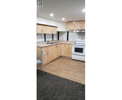 A kitchen with wooden cabinets and a white oven.
