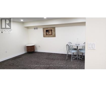A dining room with a table and chairs.