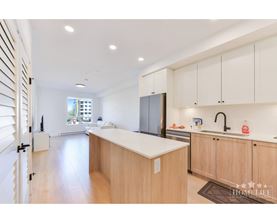 A kitchen with wooden cabinets and a white counter top.