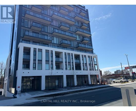 A tall white and blue building with the words "CAPITAL HILL REALTY INC., Brokerage" on the bottom.