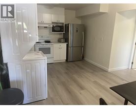 A kitchen with a refrigerator, microwave, oven, and dishwasher.
