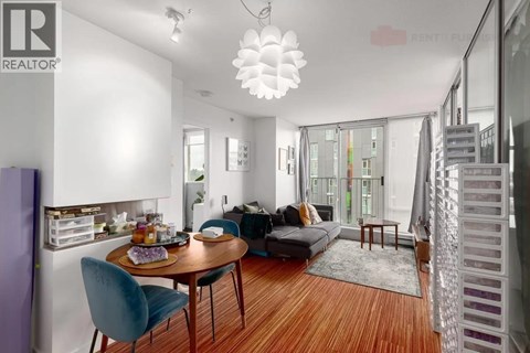A modern living room with a dining table and chairs.