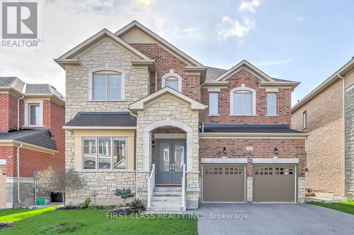 A large brick house with a garage door and a window.