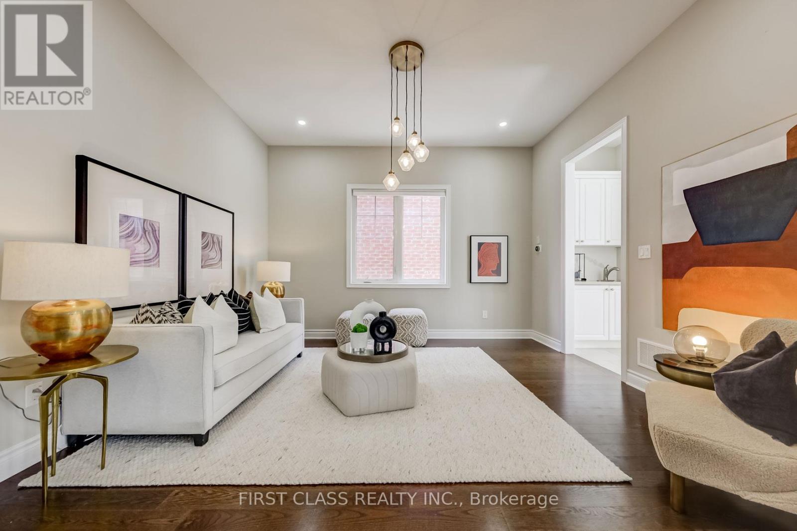 A well-lit, modern living room with a white sofa and a coffee table.