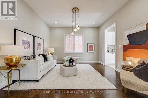 A well-lit, modern living room with a white sofa and a coffee table.