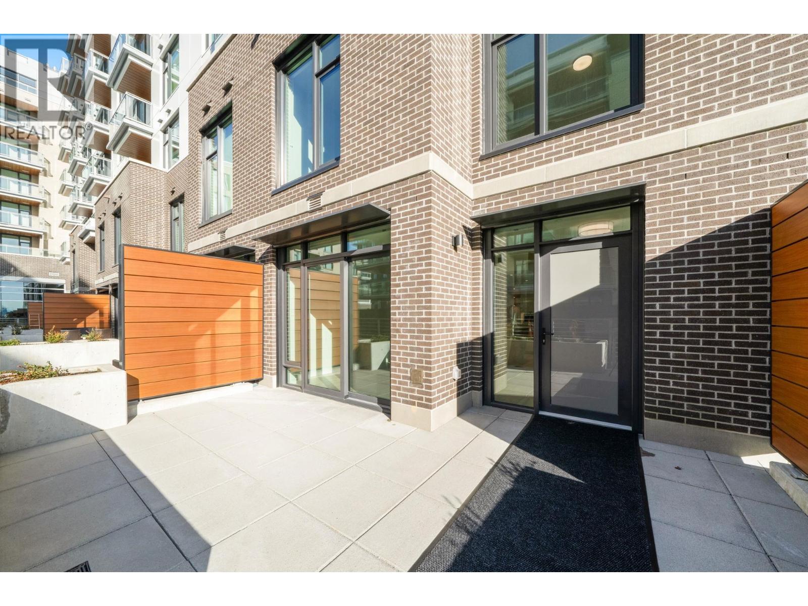 A modern building with a glass door and windows.