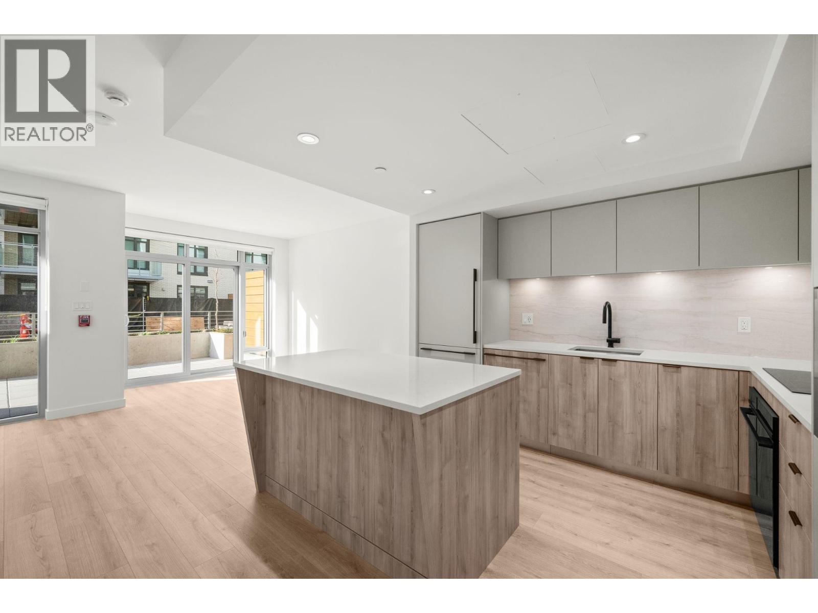 A modern kitchen with wooden cabinets and a large island.
