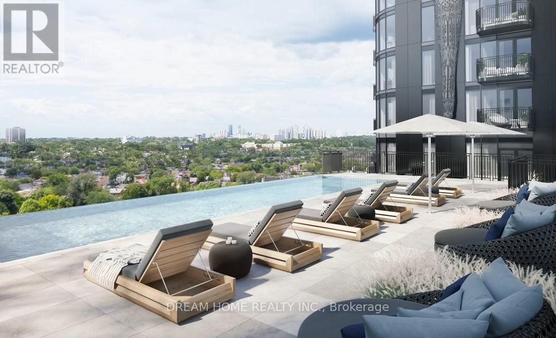 A poolside lounge area with chairs and a view of the city.