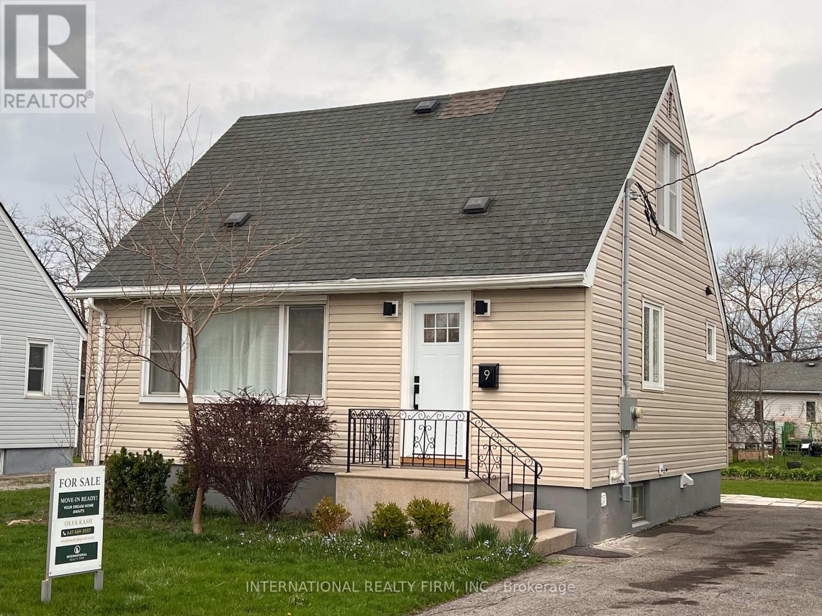 A house with a "For Sale" sign in front of it.