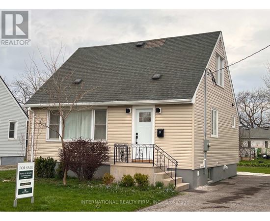 A house with a "For Sale" sign in front of it.