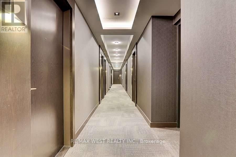 A long hallway with doors on both sides and a sign that says REALTOR.