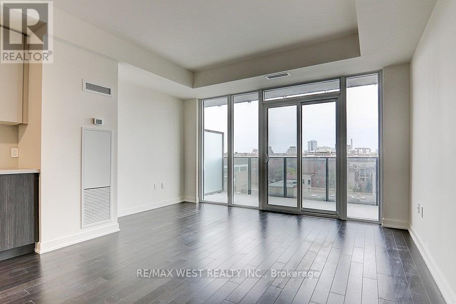 A spacious room with a view of the city through large windows.