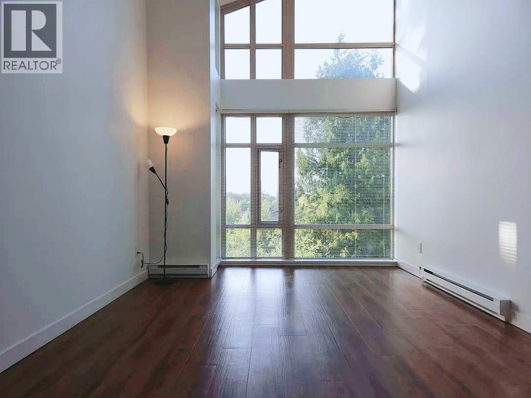 A room with a wooden floor and a large window.
