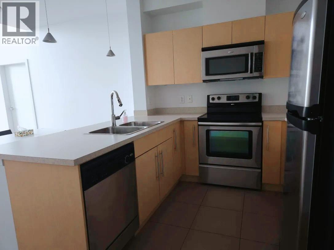 A kitchen with a stove top oven and a microwave above it.