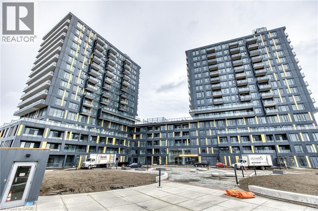 Two large buildings under construction with a grey sky in the background.