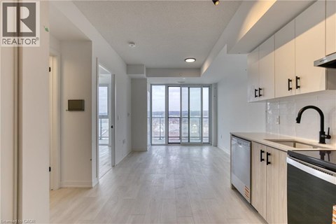 A modern kitchen with a microwave oven and a sink.