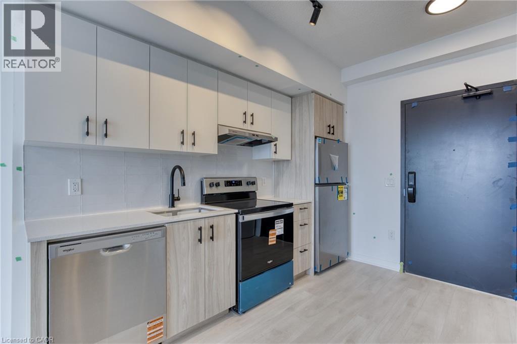 A kitchen with white cabinets and a blue fridge.
